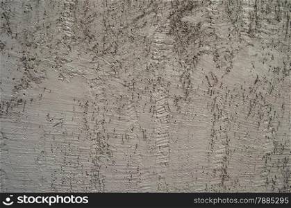 Gray painted rough plaster facade wall of house as background