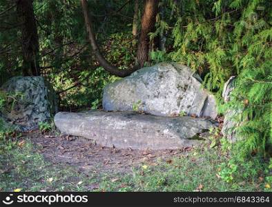 Gray stone sofa in park of the Mikhailovskoye village, Pushkinskiye Gory, Pskov region, Russia. State Museum-reserve of A. S. Pushkin.
