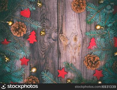 gray wood background with green spruce branches and Christmas decor, empty space