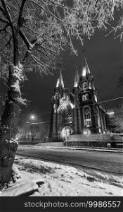 Grayscale. Beautiful illuminated night winter Church of Sts. Olha and Elizabeth in Lviv, Ukraine. Built in the years 1903-1911.