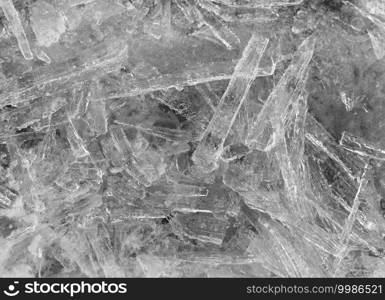 Grayscale. Many elongated pieces of ice closeup. Winter background.