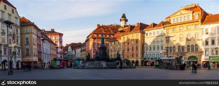 Graz, Styria / Austria - 20.01.2019: Panorama, Statue fountain in front of the town hall in Graz, Austria Painted facades and the Clock Tower in the old town of Graz, Austria Travel destination.. City square panorama. Painted facades and the Clock Tower in the old town of Graz, Austria
