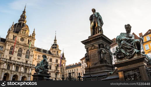 Graz, Styria / Austria - 20.01.2019: Statue fountain in front of the town hall in Graz, Austria Painted facades in the old town of Graz, Austria Travel destination.. City square. Painted facades in the old town of Graz, Austria