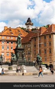 Graz, Styria,Austria - 24.06.2020: View at main square, fountain and clock tower. View at main square in Graz city, Austria