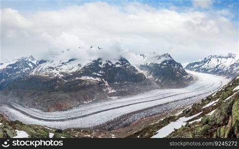 Great Aletsch Glacier and ice fall summer cloudy panorama  Bettmerhorn, Switzerland, Alps mountains 