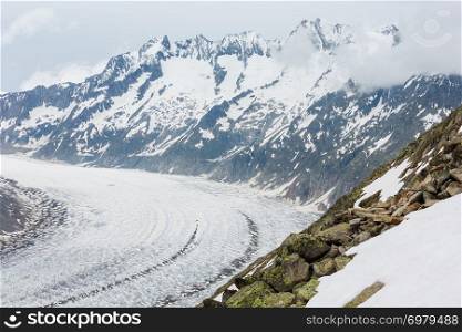 Great Aletsch Glacier and ice fall summer cloudy view (Bettmerhorn, Switzerland, Alps mountains)
