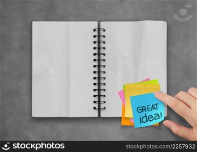 great idea word sticky notes with open blank note book on desk top texture