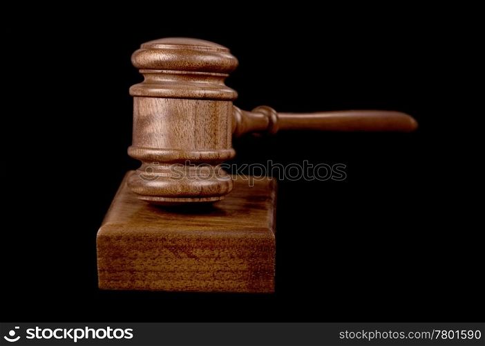 great image of a judges or auctioneers gavel on black background. gavel on black