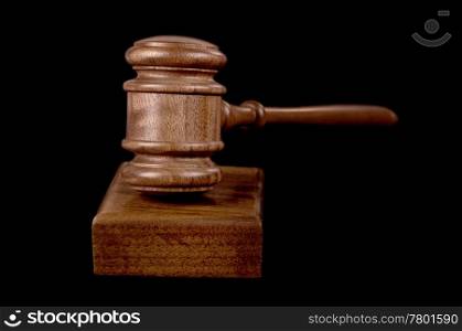 great image of a judges or auctioneers gavel on black background. gavel on black