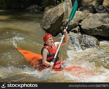 great image of a teenage facing the ordeals and challenge of white water kayaking