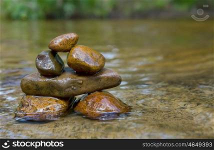 great image of tower of balancing rocks or stones in the river. balancing rocks