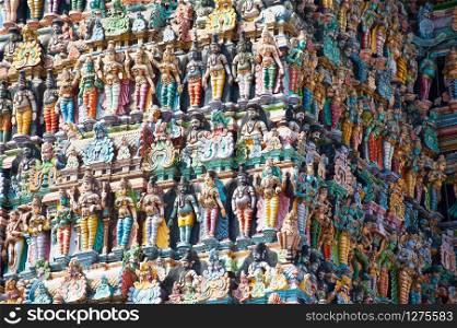 Great Indian architecture and religious art. Gods pantheon at Temple Gopuram (tower) facade Ancient colorful statues of Mahabharata Heroes South India