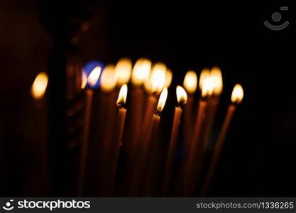 great long Candles in a church with dark background. burning candles in church on dark background. great long Candles in a church with dark background. burning candles in church on dark background.