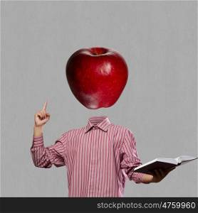 Great mind. Businessman with book in hand and apple instead of head