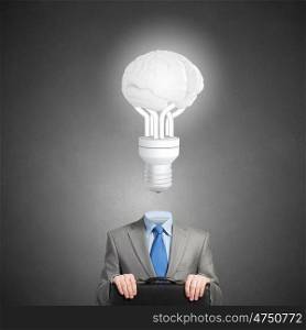 Great mind. Businessman with suitcase and light bulb instead of head