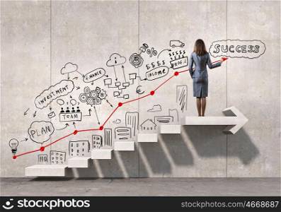 Great plan for success achieving. Businesswoman drawing strategy plan over ladder leading to success