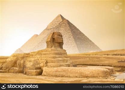 Great Sphinx and Pyramids in Giza at sunset, Egypt. Sphinx and pyramids at sunset