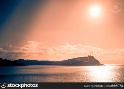 Greece Cape Sounion. Ruins of an ancient temple of Poseidon at morning sunrise, view from distance.. Greek temple of Poseidon at sunrise, Cape Sounio