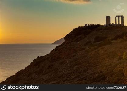 Greece Cape Sounion. Ruins of an ancient temple of Poseidon at sunset. Travel destinations.. Greek temple of Poseidon at sunset, Cape Sounio