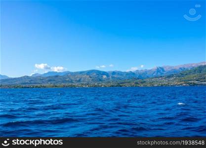 Greece. Corinthian Gulf. Wind farms on the tops of a hilly shore. View from the boat. Wind Farms on a Hilly Shore on a Sunny Day