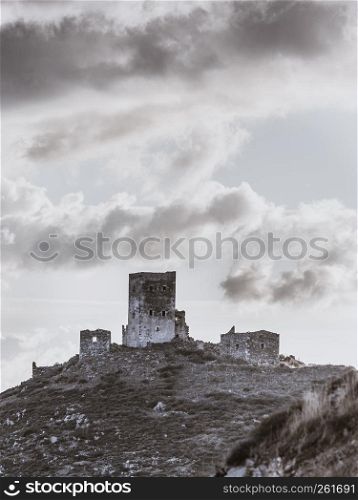 Greece Mani Peninsula. Traditional style stone tower house on hill against sky. Laconia Peloponnese, Europe. Stone old tower house on Mani, Greece.
