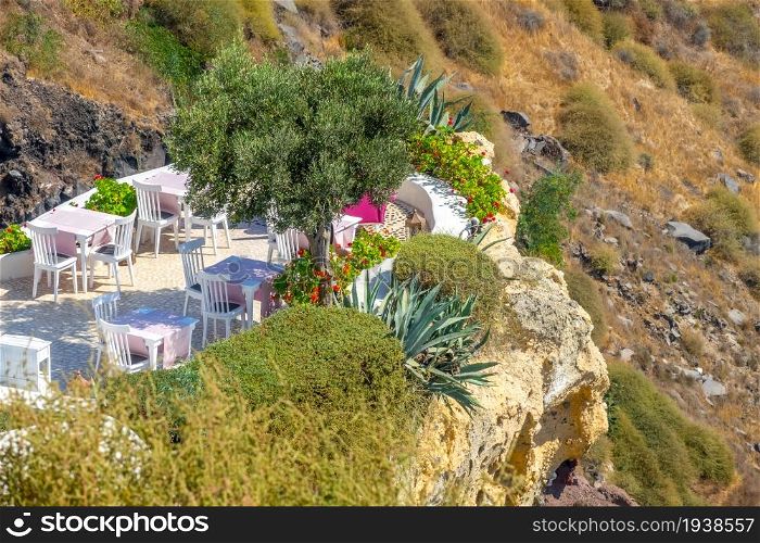 Greece. Santorini island caldera slope. Cafe on the terrace. Cafe on the Terrace of a Rocky Mountainside