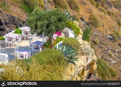 Greece. Santorini island caldera slope. Cafe on the terrace. Cafe on the Terrace of a Rocky Mountainside