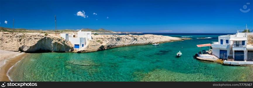 Greece scenic island panorama - small harbor with fishing boats in crystal clear turquoise water, traditishional whitewashed house. MItakas village, Milos island, Greece.. Crystal clear blue water at MItakas village beach, Milos island, Greece.