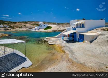 Greece scenic island view - small harbor with crystal clear turquoise water, traditishional whitewashed house. Pachena village, Milos island, Greece.. Traditional greek village - Pachena village, Milos island, Greece.