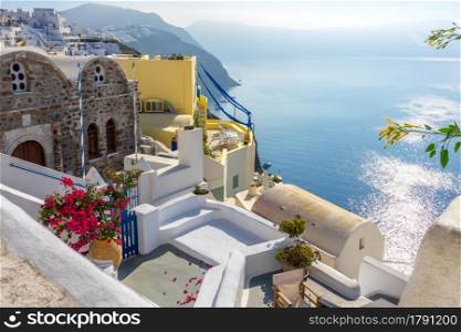 Greece. Summer sunny day at Santorini caldera. White houses and balconies in Oia with sea views. Terraces on Santorini Caldera on a Sunny Summer Day