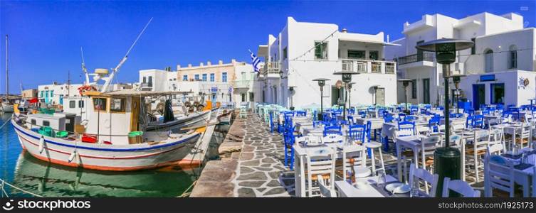 Greece travel. Cyclades, Paros island. Charming fishing village Naousa. view of port with street bars and restaurants (taverns) by the sea.
