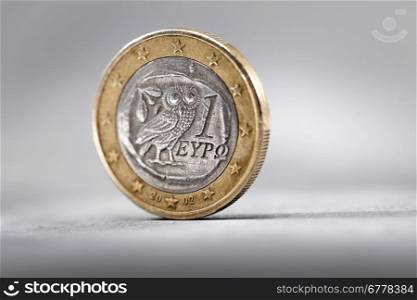 Greek 1 Euro Coin on grey background.