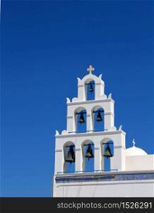 Greek bell tower againgst blue sky background. Greek church bell tower