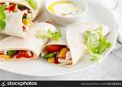 Greek chicken wraps souvlaki with vegetables and tzatziki sause