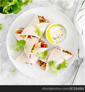 Greek chicken wraps souvlaki with vegetables and tzatziki sause. Top view