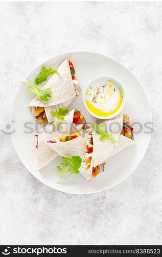 Greek chicken wraps souvlaki with vegetables and tzatziki sause. Top view