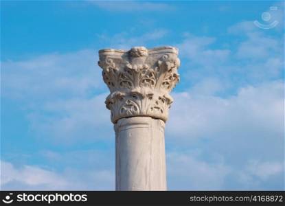 Greek column on the blue sky background