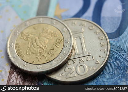 Greek Drachma and euro coin on bank note