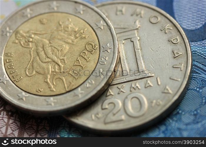 Greek Drachma and euro coin on bank note