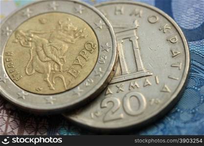 Greek Drachma and euro coin on bank note