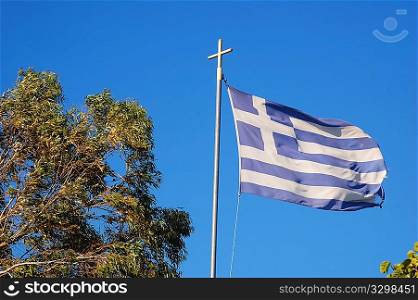 Greek flag against a mediterranean blue sky