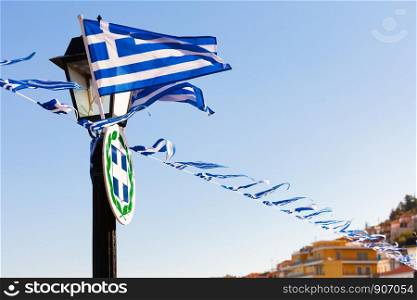 Greek flags waving outdoor on strings during summer weather. Greece European country national landmark. Greek flags waving outdoor