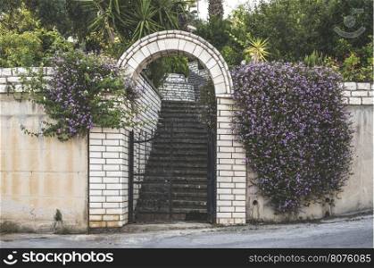 Greek house entrance with flowers.