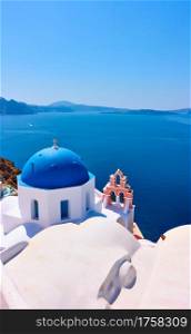 Greek landscape with church with blue dome on the shore of the Aegean sea, Santorini island, Greece