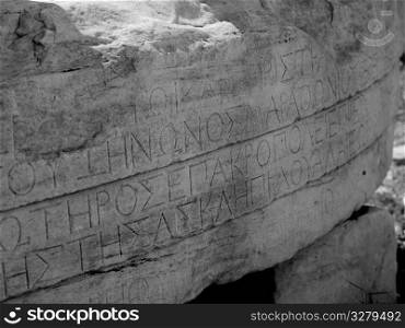 Greek lettering on ancient ruins in Athens Greece