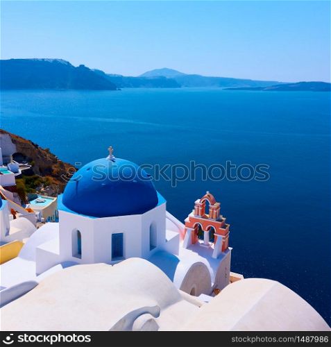 Greek orthodox church with blue dome by the sea in Oia small town in Santorini island, Greece - Landscape