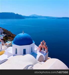 Greek orthodox church with blue dome by the sea in Oia small town in Santorini island, Greece - Landscape