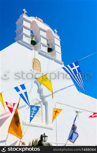 Greek othodox church drcorated by flags in celebration of religious holiday, Mykonos island, Greece