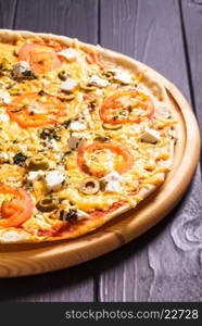 Greek pizza with olives, tomatoes and feta