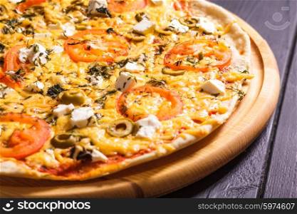 Greek pizza with olives, tomatoes and feta
